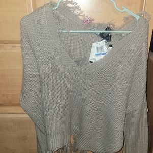 Grey or beige sweater.